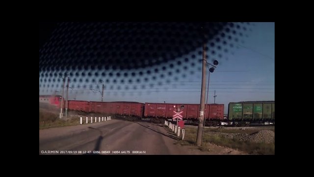 A woman drives her car directly in front of a speeding train [VIDEO]