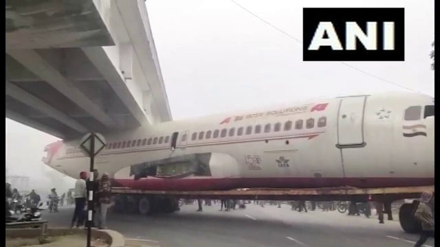 A scrapped aeroplane being transported by a truck got stuck under bridge [VIDEO]