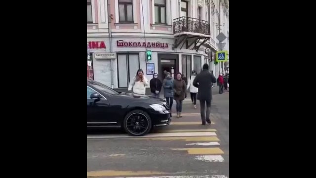 She walked over a car that stopped at a pedestrian crossing