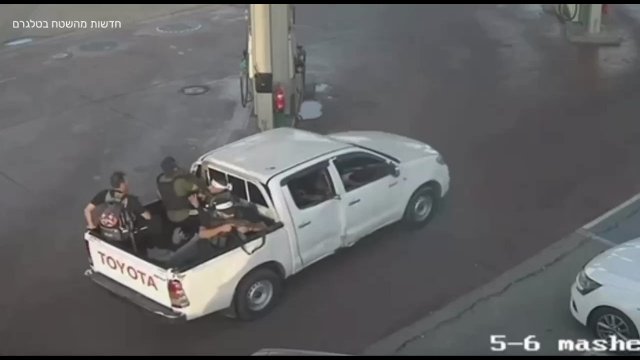 Hamas terrorist trying to break the door of a gas station with his gun [VIDEO]