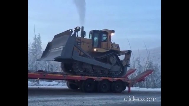 Bulldozer slips off truck