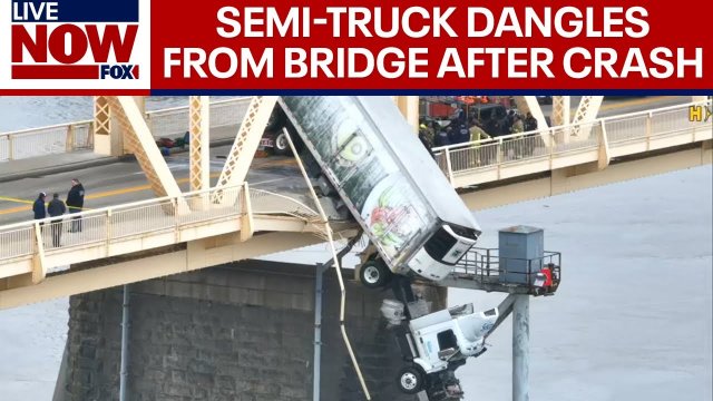 Driver rescued after semi-truck dangles from bridge [VIDEO]