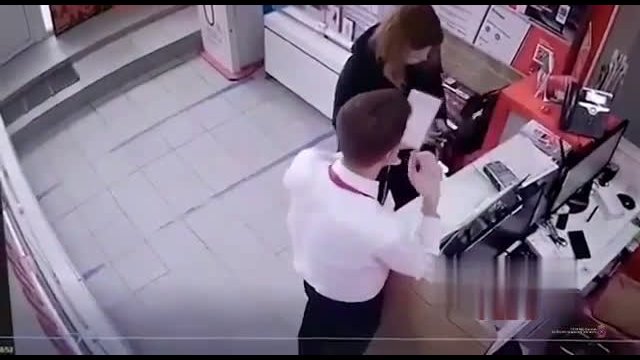 A woman tries to steal a phone using a stun gun