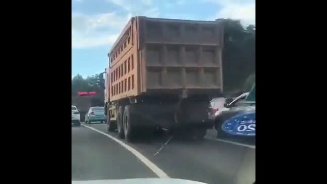 Stupidity of a girl on a motorcycle - The truck driver had no chance to see her!