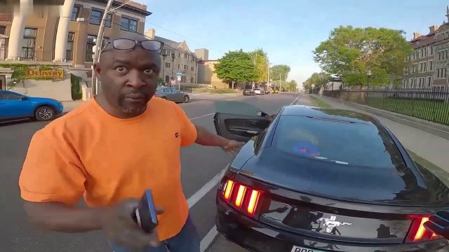 An aggressive driver scolded a cyclist who politely asked him not to park on the bike path