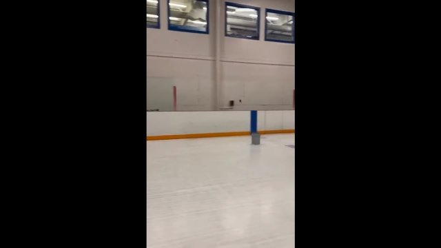 Guy lands a hockey trick shot on ice hockey rink