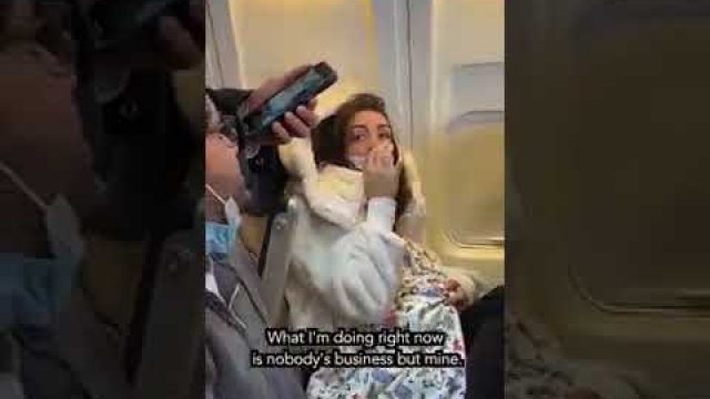 Woman breastfeeds her cat on a plane