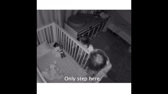 Loving brother helps cute little sister to get out of her cradle