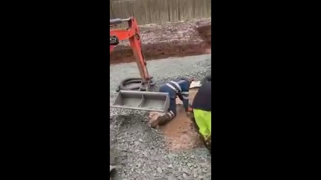 Moment digger driver shoves Scots workman into freezing dirty puddle on building site