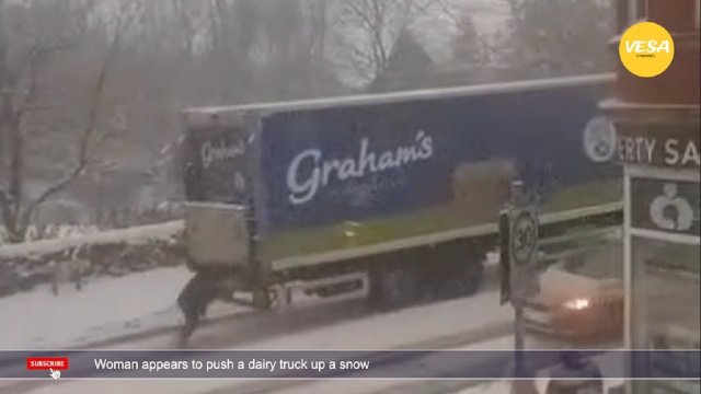 Woman appears to push a dairy truck up a snow