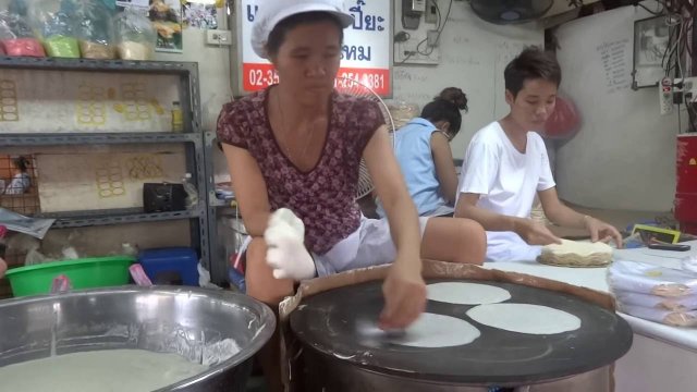 Woman prepares rice paper at a fast pace