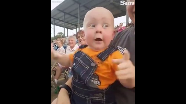 Kid gets ridiculously excited at motor racing...