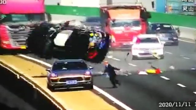 A car falls off a bridge after the tremendous impact of a truck