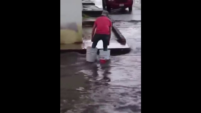 Genius! He used buckets to cross a flooded street