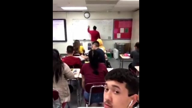 Asian teacher throwing chalk at student