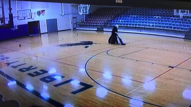 School custodian sinks backwards half-court basketball shot