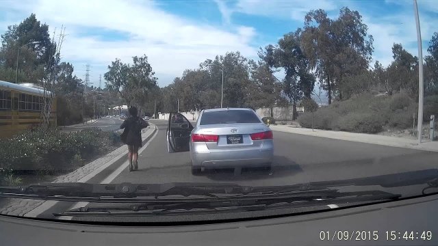 Woman jumps out of her car and causes accident!