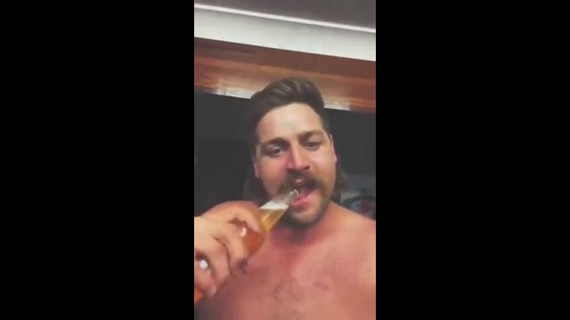 Guy flips a cigarette and then opens a beer bottle with his teeth