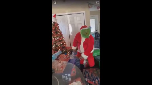 Parent in Grinch Costume Pranks Kids By Pretending to Steal Christmas Presents