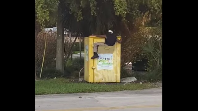 Man climbs into donation bin