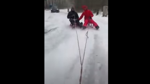 Children on a sled during a sleigh ride. Car slipped and hit a tree