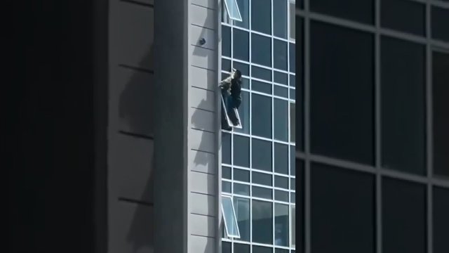 The man climbed out of his eighth floor apartment window to catch the helpless three-year-old girl
