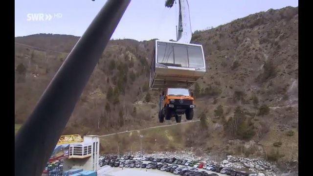 Gondola lift transporting a garbage truck for daily collection to a remote village in Switzerland