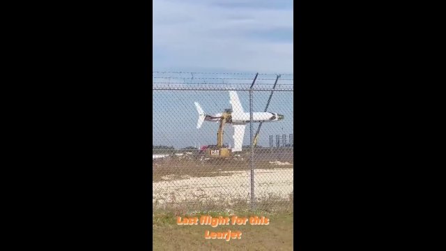 Excavator Lifts And Spins Old Plane