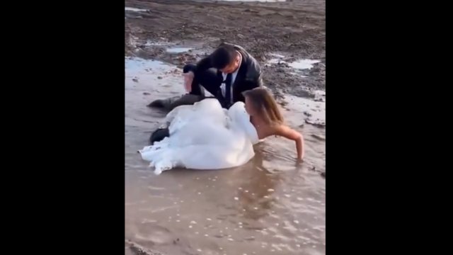 Hilarious moment newly-wed couple falling in muddy during photoshoot