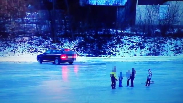 By car on the frozen river, children were playing next to it.