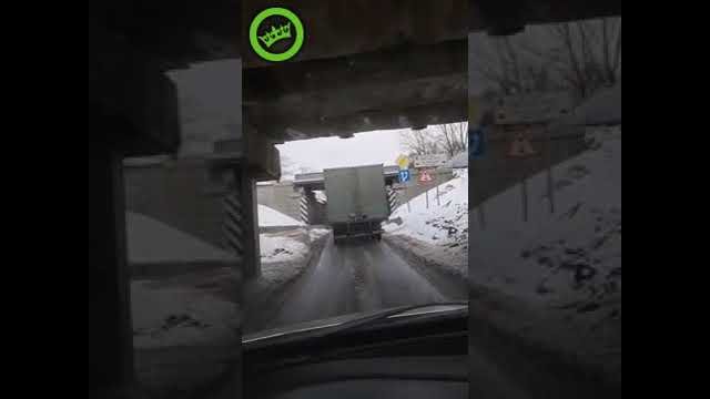 Truck tries to squeeze under bridge